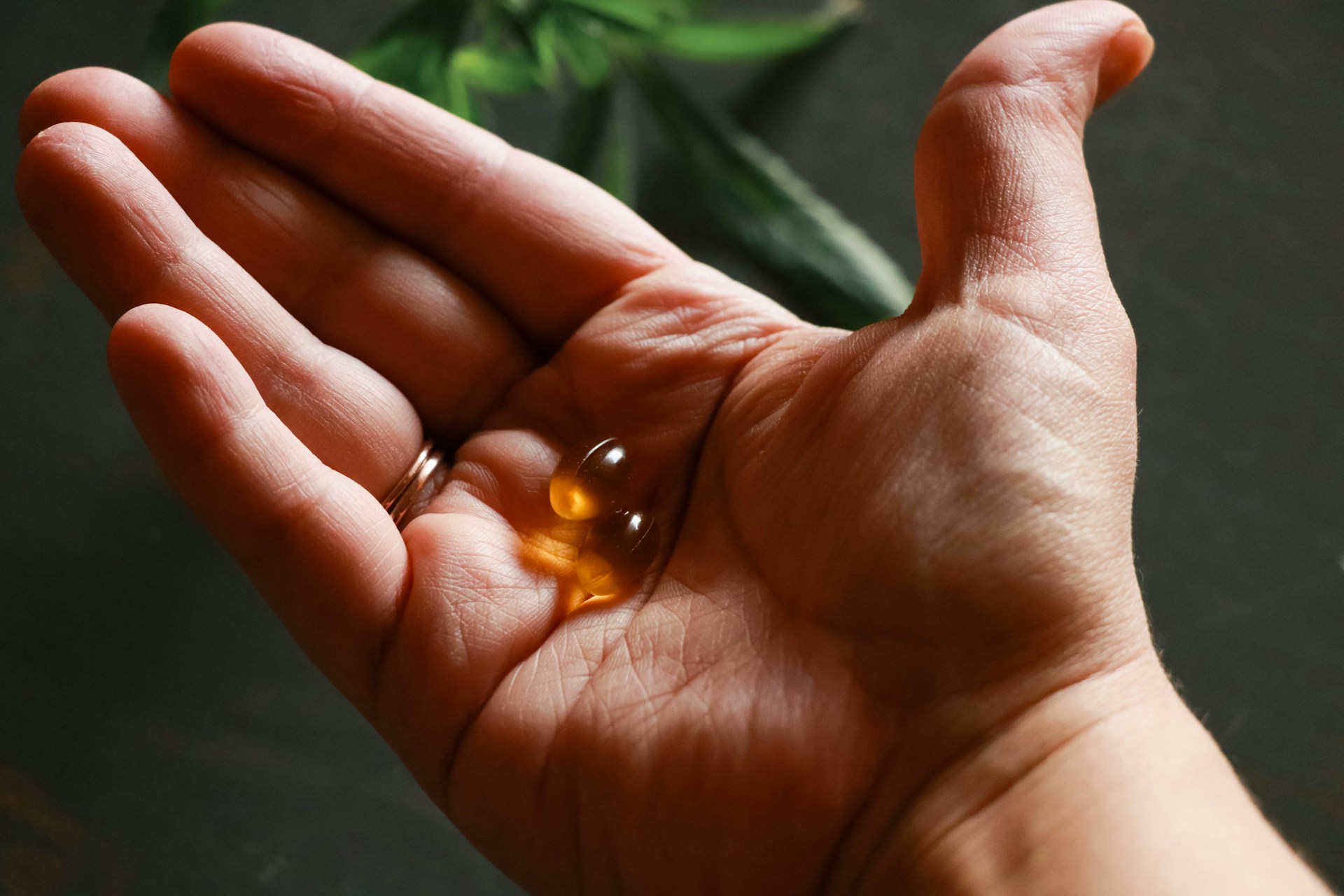 yellow-round supplement tablets on-persons-hand